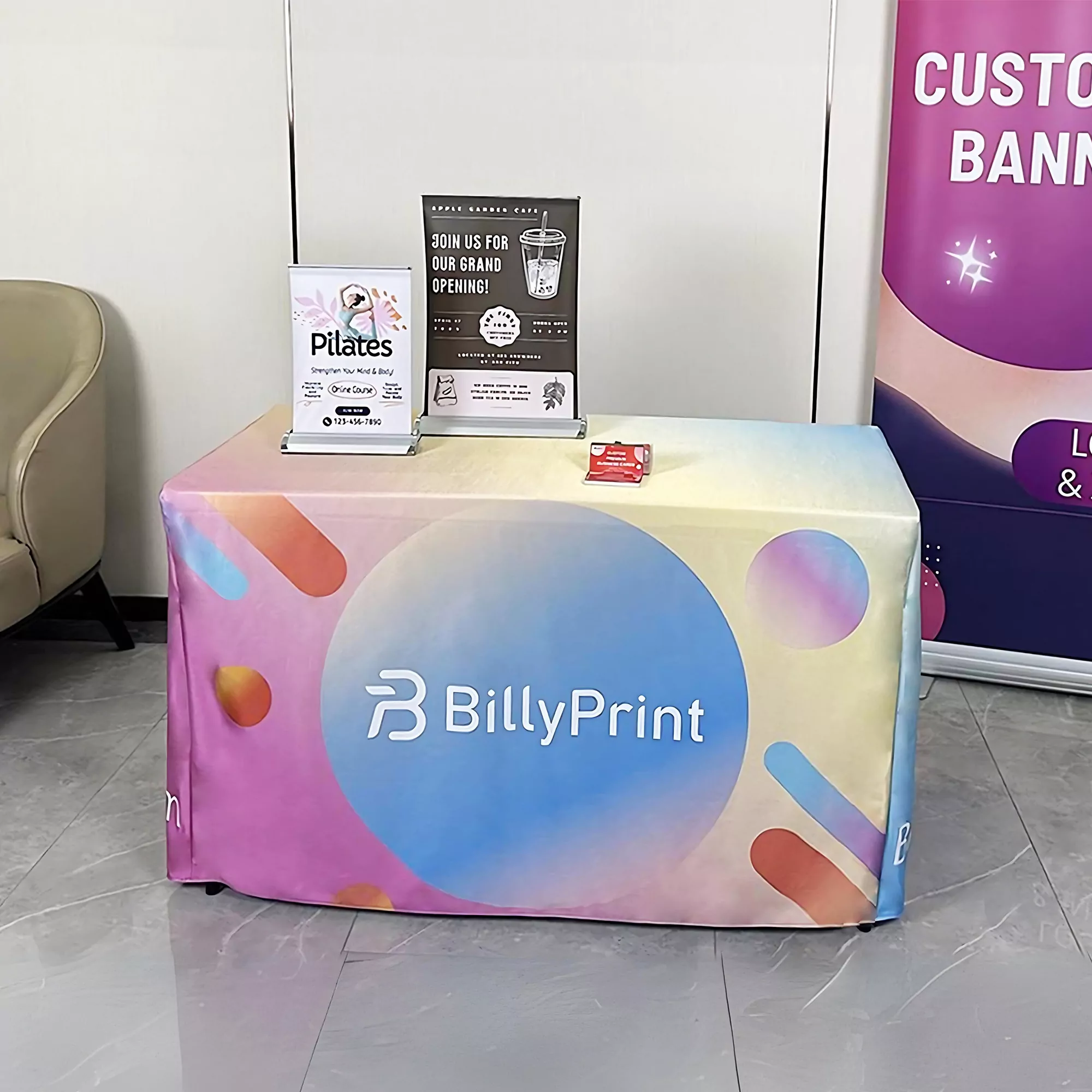 Colorful custom fitted table cloth by BillyPrint at an exhibition booth.