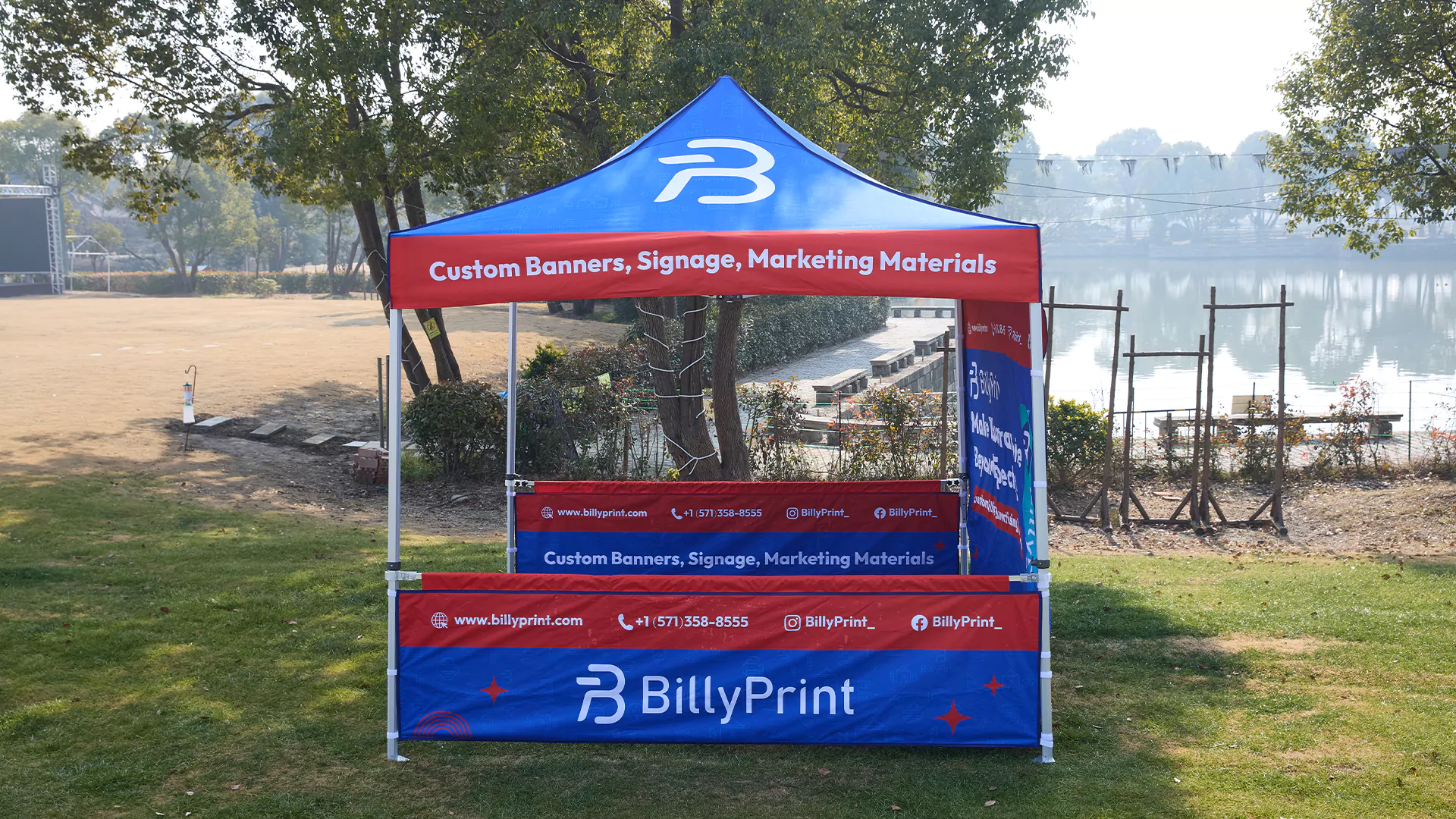 Custom pop up tents 10 x 10 with full printed canopy and side panels set up outdoors near a lake.