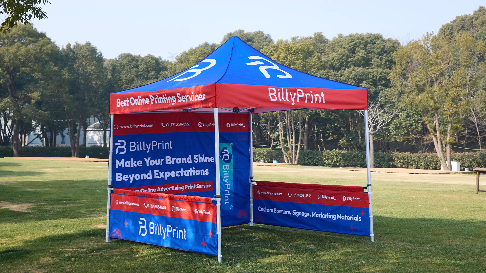 Custom 10x10 canopy tent with company logo displayed outdoors, featuring BillyPrint branding and promotional graphics for online printing services.